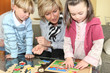 Woman and children with a wooden puzzle