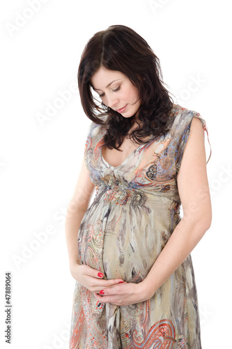 Photo: pregnant woman caressing her belly. isolated on white pregnant woman caressing her belly. isolated on white