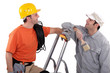 a house painter and an electrician laughing