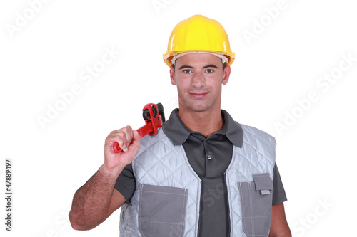 Photo: Man resting wrench on shoulder Man resting wrench on shoulder