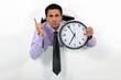 businessman showing clock looks annoyed