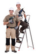 two craftsmen holding drills
