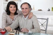 Married couple playing chess together