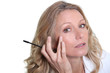 Woman applying mascara