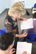 Teacher looking over her student's work