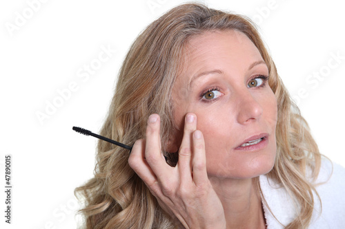 Photo: Woman applying mascara Woman applying mascara