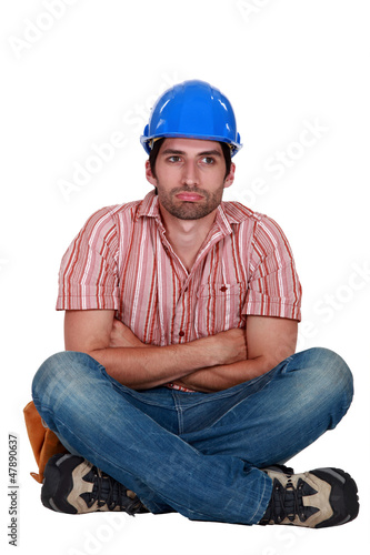 Photo: Laborer sitting with arms crossed Laborer sitting with arms crossed