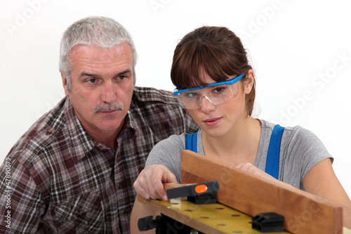 Photo: Experienced tradesman supervising his apprentice Experienced tradesman supervising his apprentice