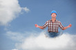 Laborer doing yoga sitting on a cloud