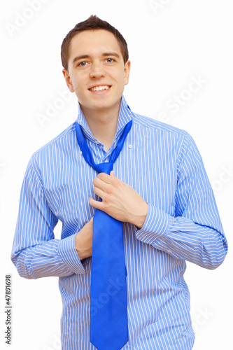 Photo: Businessman at home making his tie Businessman at home making his tie