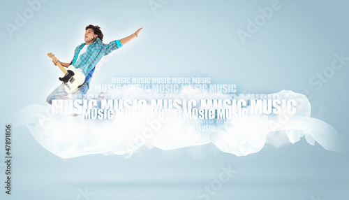 Photo: young man playing on electro guitar and jumping young man playing on electro guitar and jumping