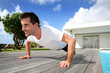 Young Man Doing Pushups On Poo...