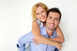 Man carrying girlfriend on his back