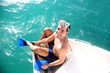Photo: Young man on a boat steps putting flippers on Young man on a boat steps putting flippers on