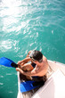 Photo: Young man on a boat steps putting flippers on Young man on a boat steps putting flippers on