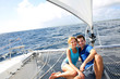 Foto: Couple relaxing on catamaran net looking at the sea Couple relaxing on catamaran net looking at the sea