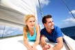 Smiling couple relaxing on a yacht by sunny day