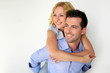 Man carrying girlfriend on his back