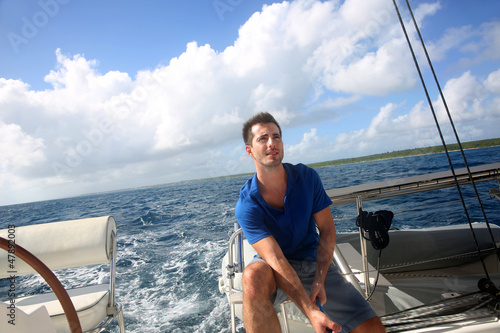 Photo: Sailot pulling on sail rope during navigation Sailot pulling on sail rope during navigation