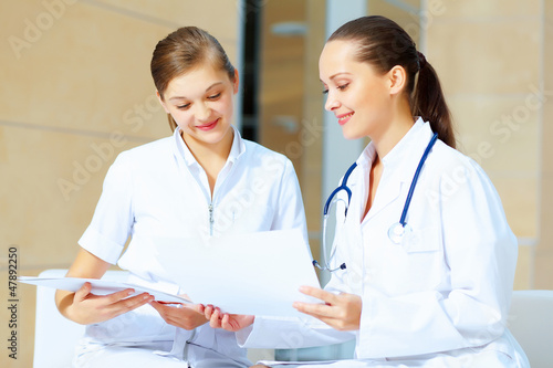 Photo: Portrait of two friendly female doctors Portrait of two friendly female doctors