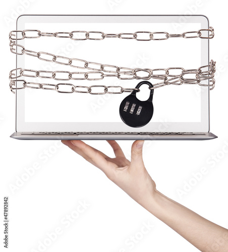 Photo: computer wrapped in chains security concept computer wrapped in chains security concept