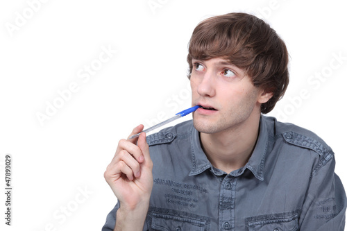 Photo: Young man daydreaming Young man daydreaming