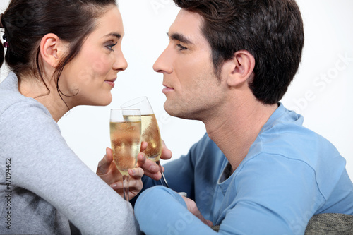 Photo: Couple having a glass of champagne Couple having a glass of champagne