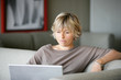 Woman using a laptop on the sofa