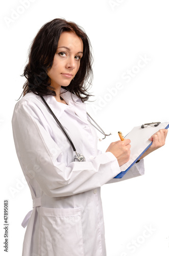 Photo: Attractive woman doctor taking notes Attractive woman doctor taking notes