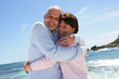Married couple hugging by the sea