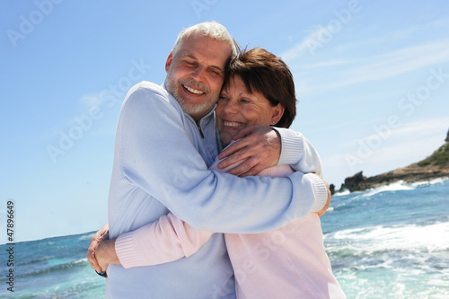 Photo: Married couple hugging by the sea Married couple hugging by the sea