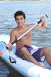 Boy paddling in canoe