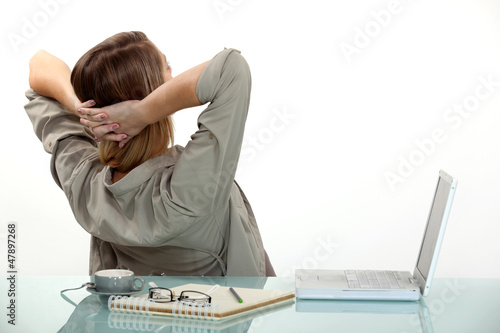 Photo: Worker relaxing at desk Worker relaxing at desk