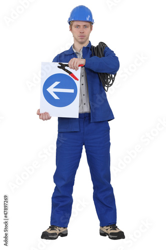 Photo: Electrician stood with coil and traffic sign Electrician stood with coil and traffic sign