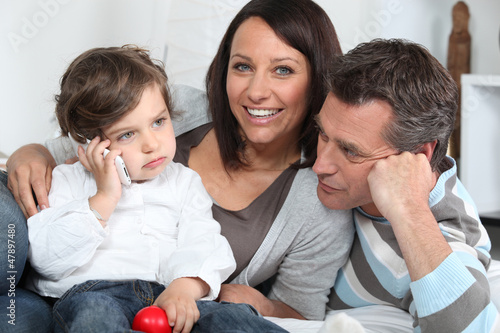Photo: Happy young family sat together Happy young family sat together