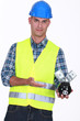 Manual worker holding piggy-bank