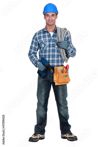 Photo: An electrician with a drill. An electrician with a drill.