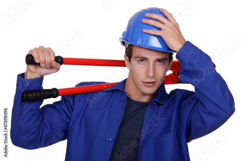 Photo: Manual worker posing with bolt cutters Manual worker posing with bolt cutters