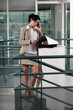Executive with folders on the phone