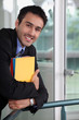 Smiling businessman holding files