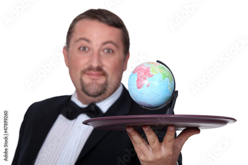 Photo: Waiter with a globe on a platter Waiter with a globe on a platter