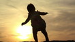 Video: Silhouette of adorable baby girl walking over sunset Silhouette of adorable baby girl walking over sunset
