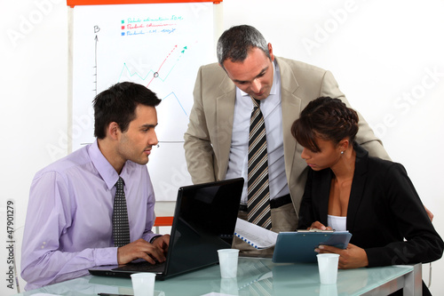 Photo: A team of business professionals working together A team of business professionals working together
