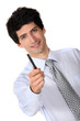 Businessman holding out a pen