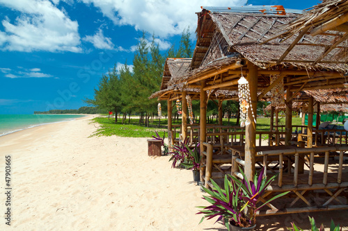 Photo: Tropical beach scenery with huts in Thailand Tropical beach scenery with huts in Thailand