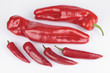 Photo: Long red peppers and chillies over white background Long red peppers and chillies over white background
