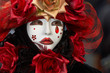 Person in Venetian costume attends Carnival of Venice.
