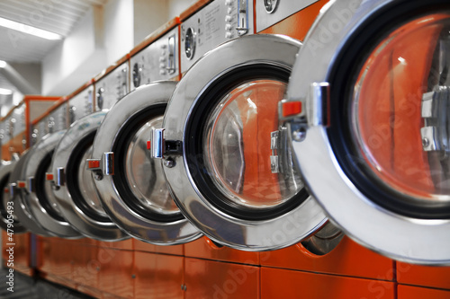 Photo: Row of washing machines in laundromat Row of washing machines in laundromat