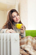 Photo: woman near oil heater woman near oil heater