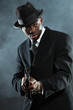 Black american mafia gangster man in suit with gun.